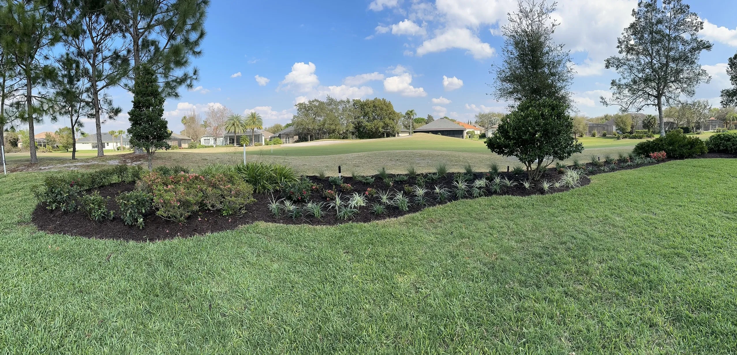 A professional installs a sprinkler system in a residential yard. The system is designed to keep the lawn and plants hydrated.